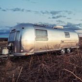 Brookvale, Canada - April 17, 2013: An Airstream International Overlander travel trailer parked in a field along a rural backroad.